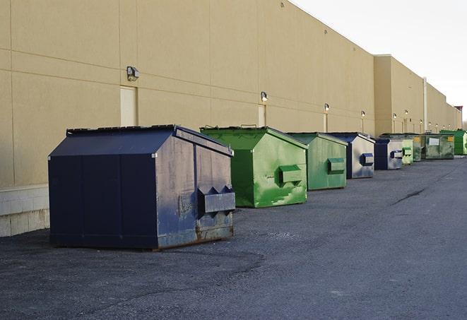 a red construction dumpster placed in front of a building under construction in Briny Breezes, FL